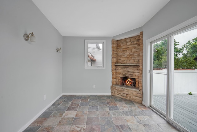 3061 Xavier Ct, Oceanside, NY 11572 - unfurnished living room with stone tile floors, a fireplace, and baseboards