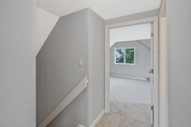 3061 Xavier Ct, Oceanside, NY 11572 - hall with an upstairs landing, lofted ceiling, light colored carpet, and baseboards