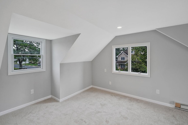 3061 Xavier Ct, Oceanside, NY 11572 - bonus room with healthy amount of natural light, carpet flooring, baseboards, lofted ceiling, and a baseboard radiator