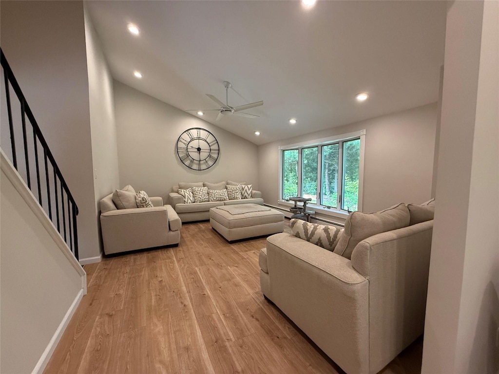 44 Woodbine St, Coram, NY 11727 - living room with light wood-style flooring, recessed lighting, ceiling fan, vaulted ceiling, and stairs