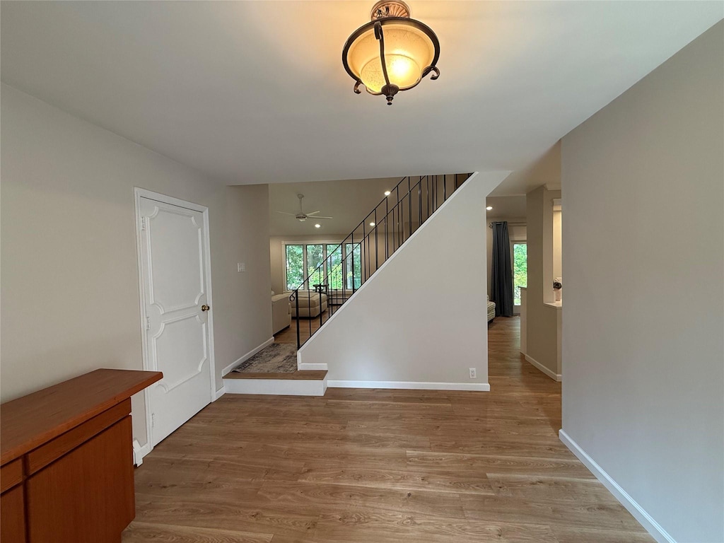 44 Woodbine St, Coram, NY 11727 - foyer with light wood-style flooring, stairs, baseboards, and ceiling fan