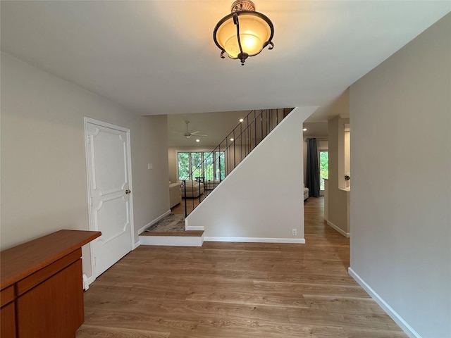 44 Woodbine St, Coram, NY 11727 - foyer with light wood-style flooring, stairs, baseboards, and ceiling fan