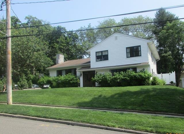 16 Bayview Ave, Port Washington, NY 11050 - split level home featuring a chimney