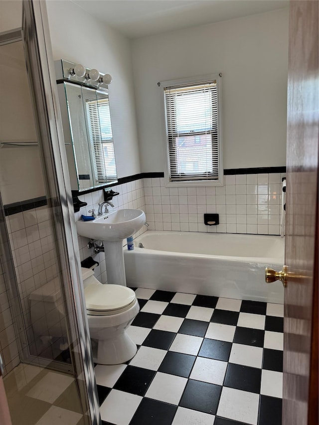 6472 84th St, Middle Village, NY 11379 - bathroom featuring plenty of natural light, a bath, tile walls, a stall shower, and tile patterned floors