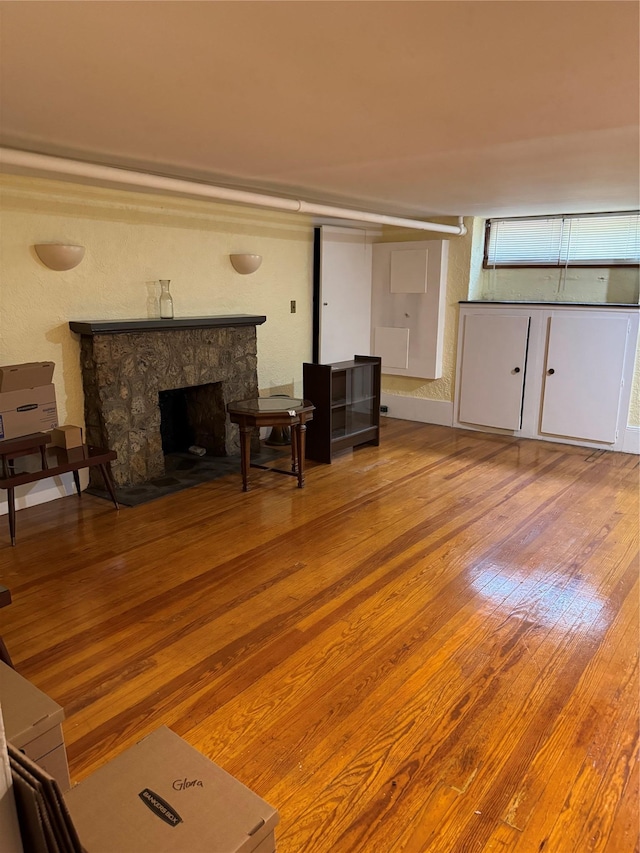6472 84th St, Middle Village, NY 11379 - living room featuring wood finished floors and a stone fireplace