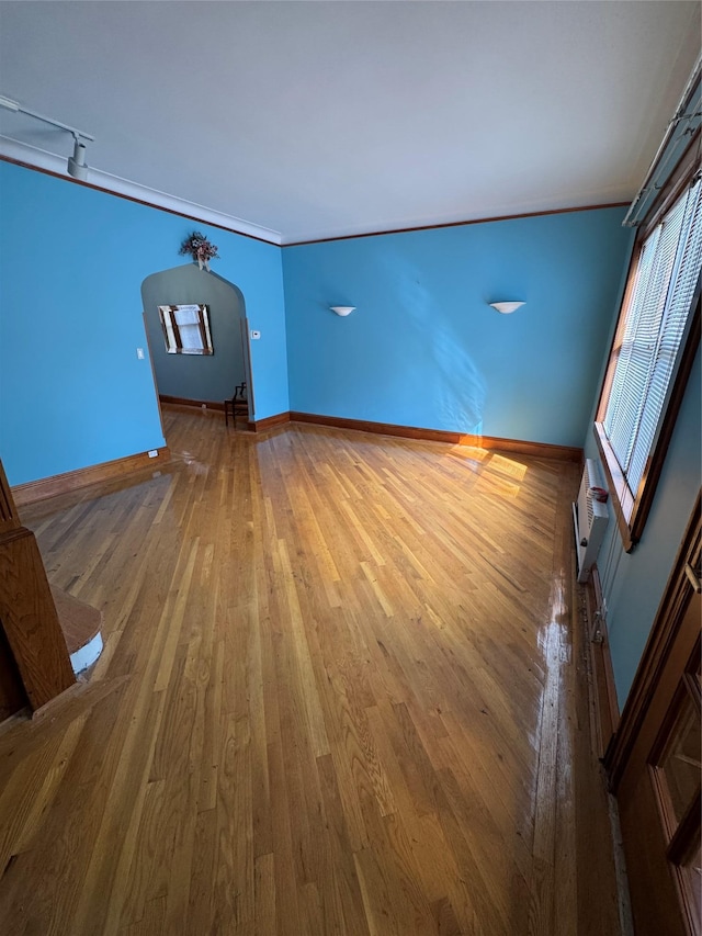 6472 84th St, Middle Village, NY 11379 - unfurnished room featuring hardwood / wood-style flooring, arched walkways, and a wall mounted AC