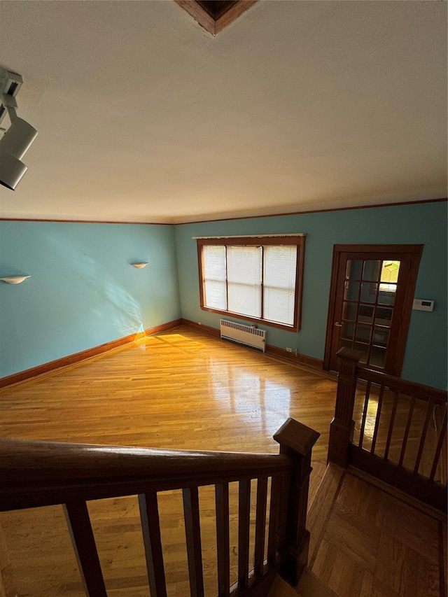 6472 84th St, Middle Village, NY 11379 - spare room featuring radiator heating unit and parquet floors