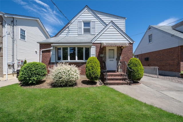 8123 260th St, Glen Oaks, NY 11004 - view of front of home with brick siding and a front lawn