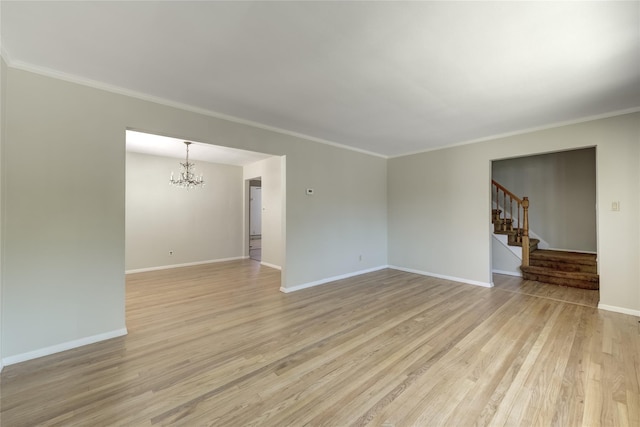 8123 260th St, Glen Oaks, NY 11004 - spare room with a chandelier, light wood finished floors, stairs, crown molding, and baseboards