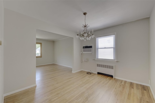 8123 260th St, Glen Oaks, NY 11004 - empty room with radiator heating unit, a chandelier, wood finished floors, a wall unit AC, and baseboards