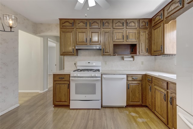 8123 260th St, Glen Oaks, NY 11004 - kitchen featuring white appliances, light wood-type flooring, under cabinet range hood, a ceiling fan, and brown cabinetry