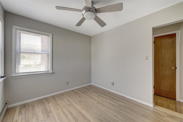 8123 260th St, Glen Oaks, NY 11004 - unfurnished room with light wood finished floors, baseboard heating, baseboards, and a ceiling fan