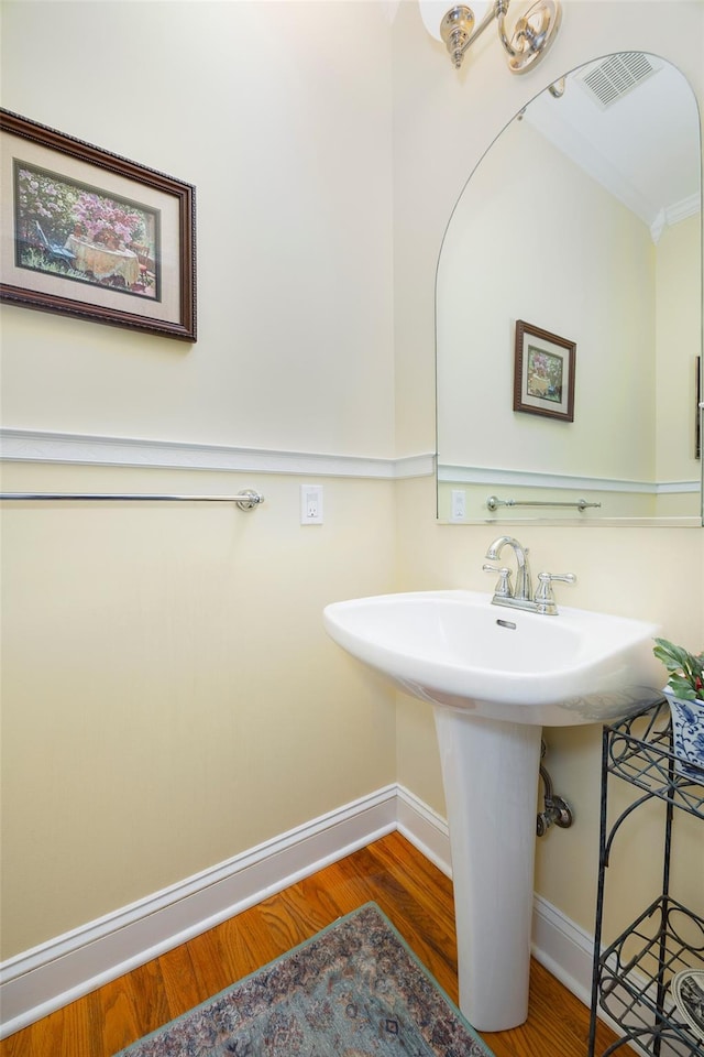 3 Cambridge Ct, Wappingers Falls, NY 12590 - bathroom featuring baseboards, wood finished floors, and ornamental molding