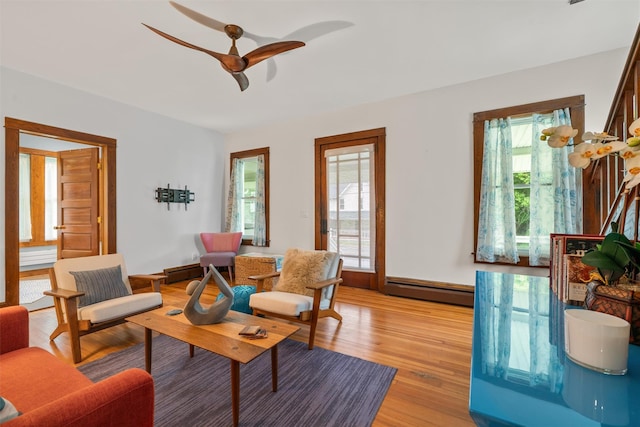 858 N Branch Hortonville Rd, North Branch, NY 12745 - living room featuring a baseboard heating unit, ceiling fan, plenty of natural light, and light wood-style floors