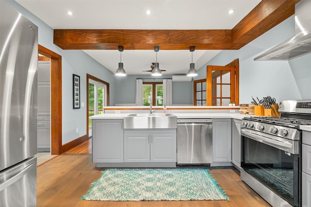 858 N Branch Hortonville Rd, North Branch, NY 12745 - kitchen featuring appliances with stainless steel finishes, a sink, wall chimney exhaust hood, light wood finished floors, and beam ceiling