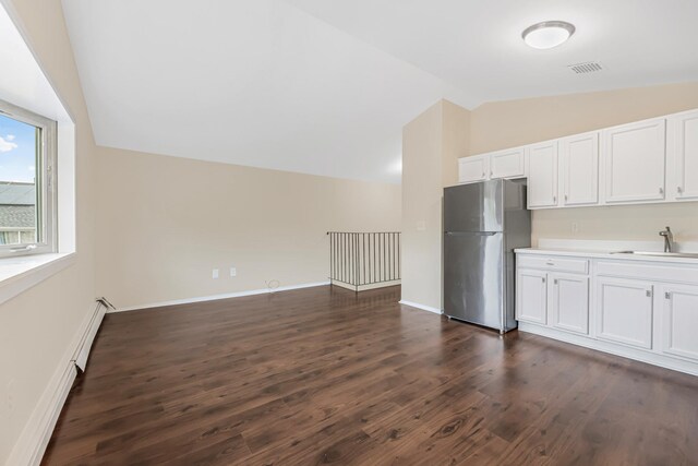 3665 Varian Ave, Bronx, NY 10466 - kitchen with freestanding refrigerator, lofted ceiling, a sink, dark wood-style flooring, and white cabinets