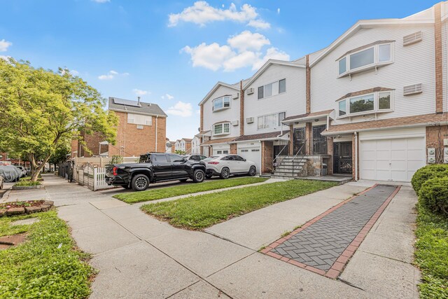 3665 Varian Ave, Bronx, NY 10466 - view of front of property with a residential view, an attached garage, and concrete driveway