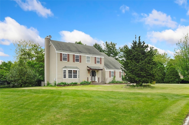 49 Tallmadge Trl, Miller Place, NY 11764 - colonial inspired home featuring a chimney and a front lawn