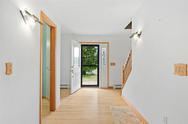 49 Tallmadge Trl, Miller Place, NY 11764 - foyer featuring light wood-style flooring, a baseboard heating unit, stairs, and baseboards