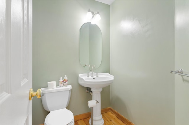 49 Tallmadge Trl, Miller Place, NY 11764 - half bathroom featuring toilet, wood finished floors, and baseboards