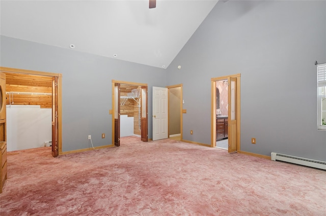 49 Tallmadge Trl, Miller Place, NY 11764 - unfurnished bedroom featuring a spacious closet, high vaulted ceiling, a baseboard heating unit, carpet floors, and connected bathroom