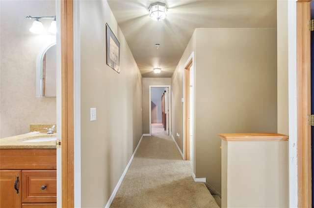 49 Tallmadge Trl, Miller Place, NY 11764 - corridor with a sink, light carpet, and baseboards