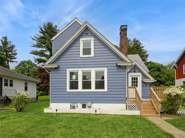 34 Woodland Ave, Poughkeepsie, NY 12603 - back of house with a lawn and a chimney