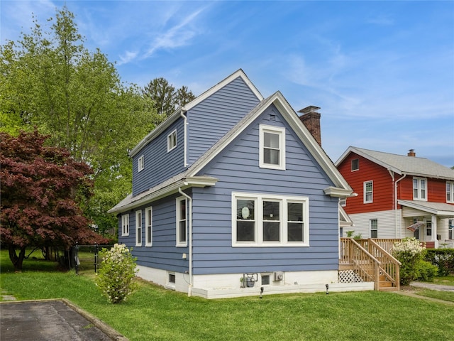 34 Woodland Ave, Poughkeepsie, NY 12603 - view of home's exterior featuring a lawn and a chimney