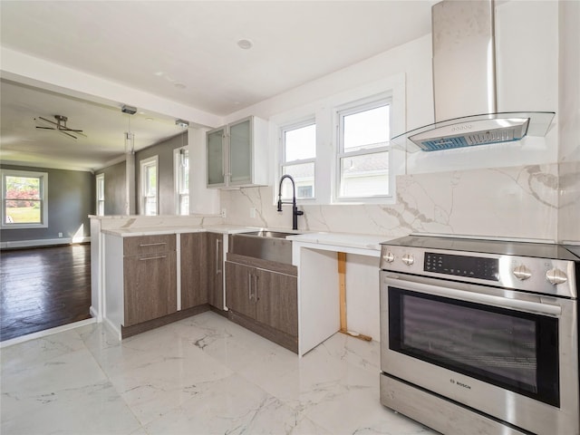 34 Woodland Ave, Poughkeepsie, NY 12603 - kitchen with stainless steel electric stove, exhaust hood, a sink, and plenty of natural light