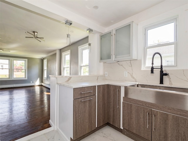 34 Woodland Ave, Poughkeepsie, NY 12603 - kitchen featuring a sink, healthy amount of natural light, a peninsula, and light stone countertops