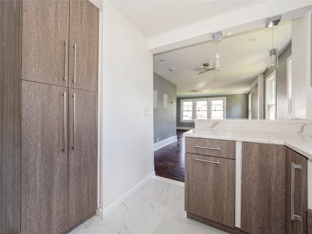 34 Woodland Ave, Poughkeepsie, NY 12603 - kitchen with light stone countertops, light marble finish flooring, baseboards, open floor plan, and a peninsula