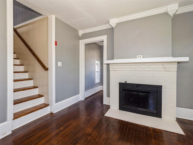 34 Woodland Ave, Poughkeepsie, NY 12603 - unfurnished living room featuring hardwood / wood-style floors, baseboards, ornamental molding, a brick fireplace, and stairway