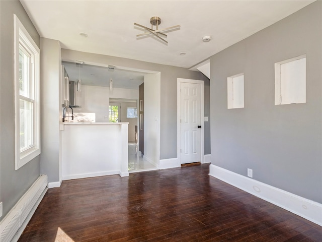 34 Woodland Ave, Poughkeepsie, NY 12603 - unfurnished living room featuring a baseboard heating unit, wood finished floors, baseboards, and a ceiling fan