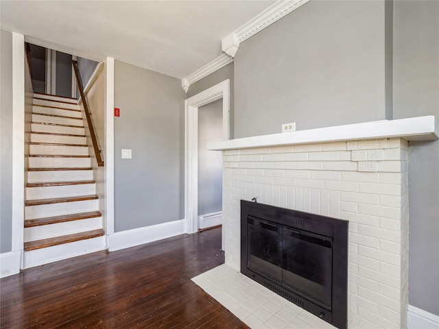 34 Woodland Ave, Poughkeepsie, NY 12603 - unfurnished living room with hardwood / wood-style flooring, a fireplace, baseboards, stairway, and ornamental molding