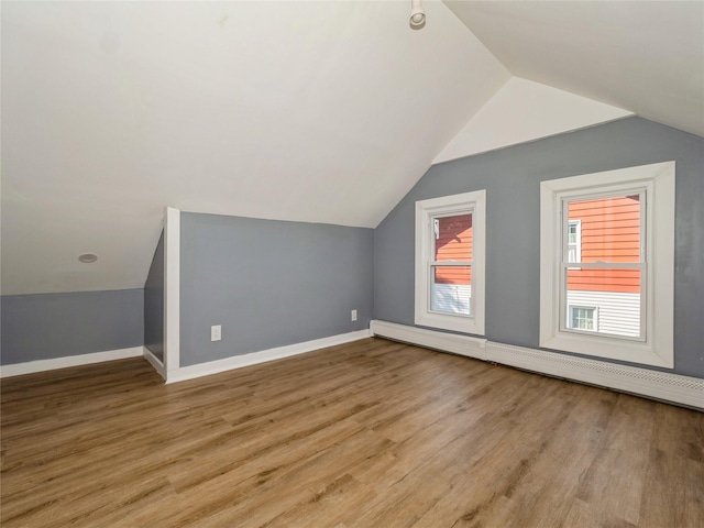 34 Woodland Ave, Poughkeepsie, NY 12603 - additional living space featuring a baseboard radiator, vaulted ceiling, wood finished floors, and baseboards