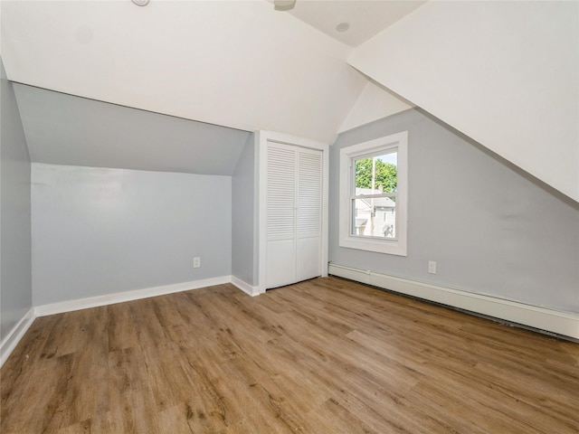 34 Woodland Ave, Poughkeepsie, NY 12603 - additional living space featuring vaulted ceiling, wood finished floors, a baseboard heating unit, and baseboards