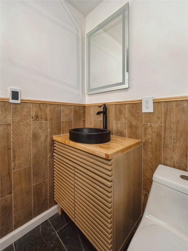 34 Woodland Ave, Poughkeepsie, NY 12603 - half bath with a wainscoted wall, vanity, toilet, and marble look tile flooring