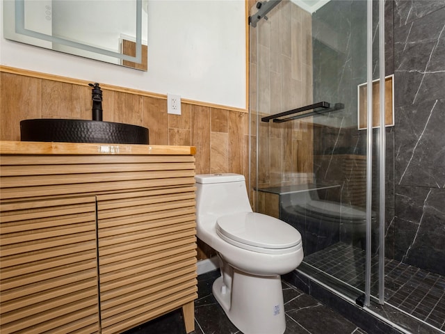34 Woodland Ave, Poughkeepsie, NY 12603 - full bath featuring toilet, vanity, a shower stall, a wainscoted wall, and tile walls