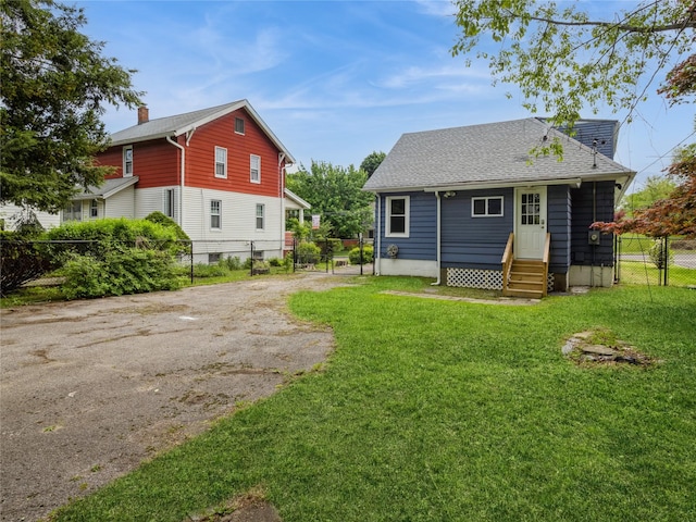 34 Woodland Ave, Poughkeepsie, NY 12603 - rear view of house featuring entry steps, driveway, roof with shingles, and a gate