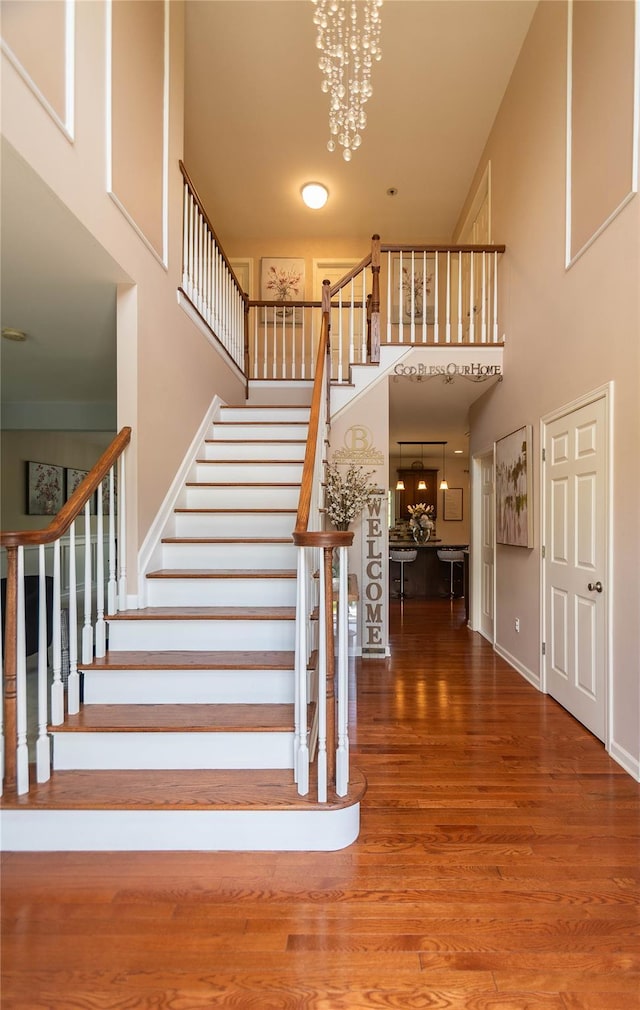 38 Panorama Dr, New Windsor, NY 12553 - stairway featuring a towering ceiling, wood finished floors, a chandelier, and baseboards