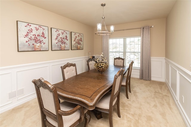 38 Panorama Dr, New Windsor, NY 12553 - dining space with a chandelier, a decorative wall, light carpet, and a wainscoted wall