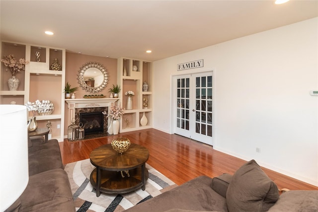 38 Panorama Dr, New Windsor, NY 12553 - living room featuring french doors, wood finished floors, a fireplace, recessed lighting, and built in shelves