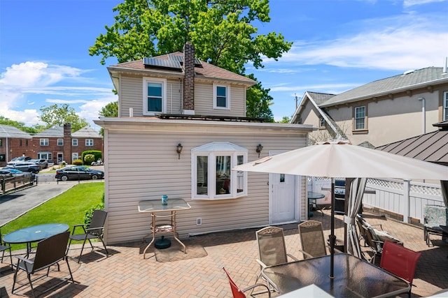 1370 Kearney Ave, Bronx, NY 10465 - rear view of property with outdoor dining space, a patio, and solar panels