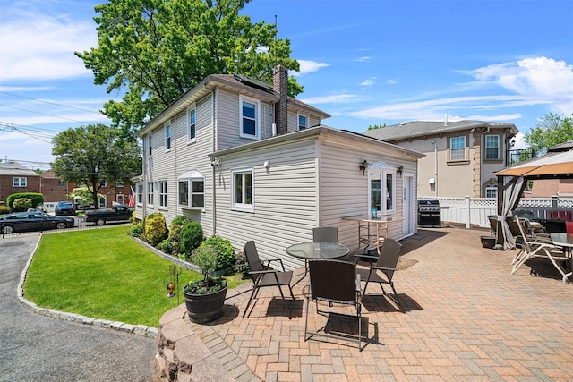 1370 Kearney Ave, Bronx, NY 10465 - rear view of house with a gazebo, a chimney, a patio, and outdoor dining area