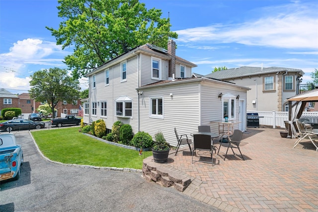 1370 Kearney Ave, Bronx, NY 10465 - back of property with a chimney, a patio area, a gazebo, and outdoor dining space