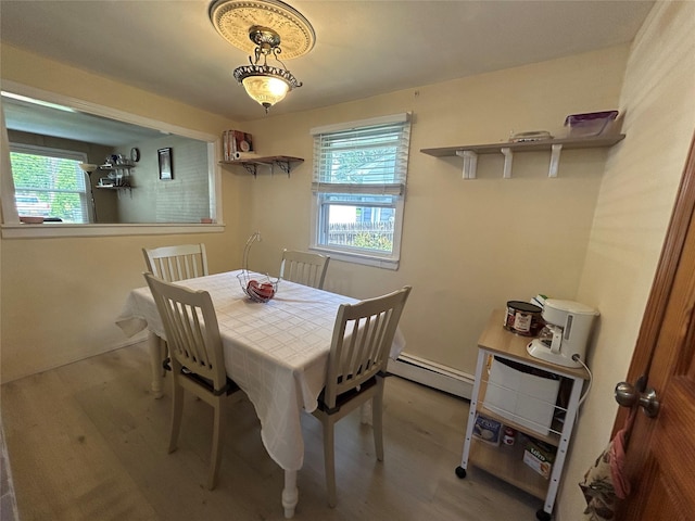 50 Tangier Dr, Sound Beach, NY 11789 - dining space with wood finished floors, healthy amount of natural light, and baseboard heating