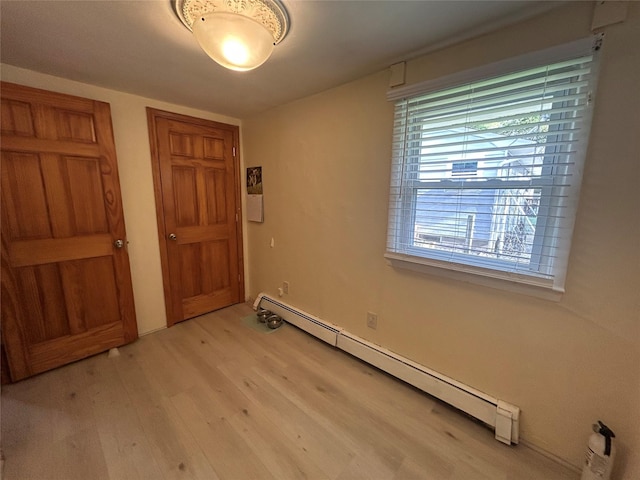 50 Tangier Dr, Sound Beach, NY 11789 - interior space with a baseboard heating unit, light wood-type flooring, and a closet