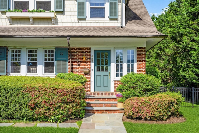 489 Manor Ln, Pelham, NY 10803 - doorway to property with a shingled roof and brick siding