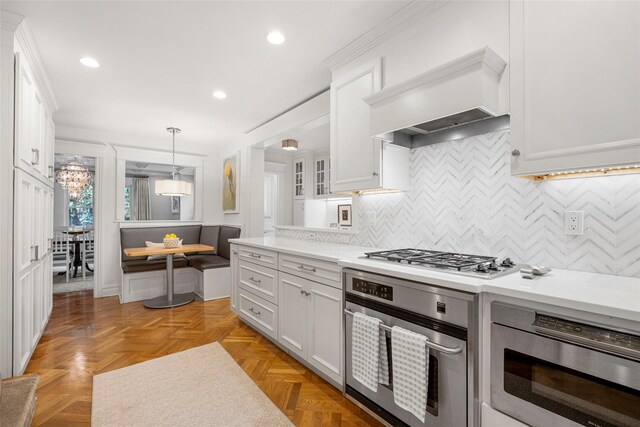489 Manor Ln, Pelham, NY 10803 - kitchen featuring appliances with stainless steel finishes, white cabinets, light countertops, and recessed lighting