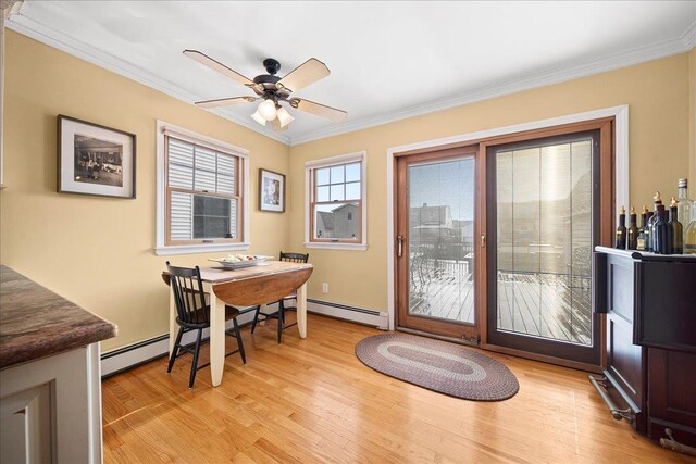 16 Gibbs Rd, Amity Harbor, NY 11701 - dining area featuring light wood-type flooring, crown molding, a baseboard radiator, a ceiling fan, and baseboards